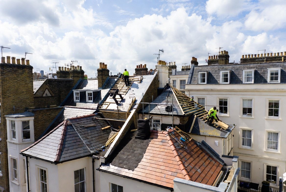 Roof replacement cost Ealing — GNP Roofing team installing a new pitched roof